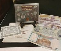Overview of coin set, certificate, envelope and banknotes