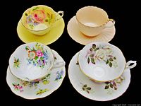 All four cup and saucer sets arranged