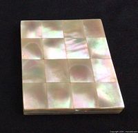 closed compact showing mother of pearl tiled lid