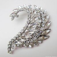 Front view of curved leaf brooch showing rhinestone arrangement