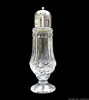 full view of crystal sugar shaker with silver-plated lid