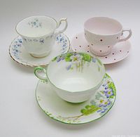 Three cup and saucer sets arranged together