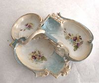 Top view of porcelain triple section candy dish showing floral painting and handle