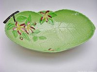 top view showing entire green leaf bowl with blossom motif and handle