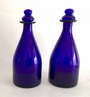 Front view of both cobalt blue bottles with stoppers inserted