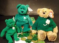 Three Ty bears with shamrock theme and gold coins background