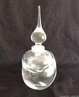 Front view of clear art glass perfume bottle with stopper