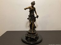 Full view of bronze sculpture on marble base