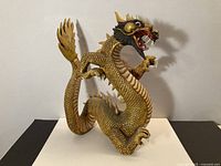 Full view of carved wood dragon sculpture