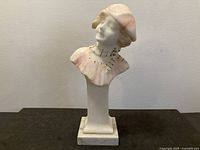 Front view of alabaster bust sculpture on column and base