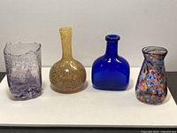 Front view of four art glass vases