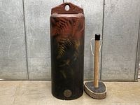 Full view of bell standing upright with striker beside