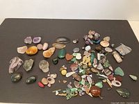 Wide view of full assortment of stones spread on black surface