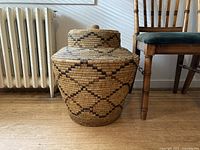 Full view of basket with lid in place beside chair and radiator