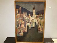 Full frontal view of framed abstract cityscape oil painting