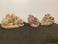 All three stone carvings together