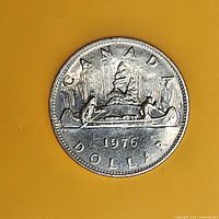 Reverse of 1976 Canadian Voyageur dollar coin showing canoe design and legends