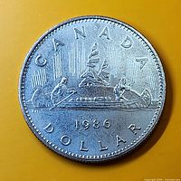 Reverse side: Voyageur canoe design, date 1986 visible