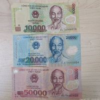 Front faces of three Vietnamese banknotes showing denominations 10,000, 20,000, 50,000 đồng