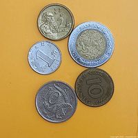 Obverse sides of five coins on yellow background