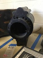 Front view of vintage Brenkert spotlight showing lens opening and partial tag beneath.