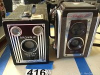 Front view of Kodak Brownie Target Six-20 and Duaflex IV cameras side by side.
