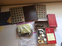 Overall view showing coin boards, binder, boxes and zip bags of coins