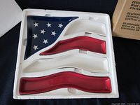 All five porcelain flag dishes in foam packaging