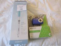 Camera and curling wand boxes side by side