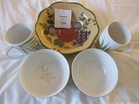 Group shot of large fruit motif bowl, two mugs, two smaller bowls