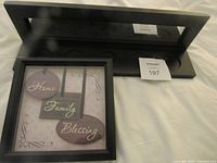 Front view of shelf and framed art showing design and text