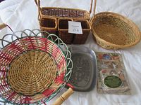 All baskets, cutting utensil set and pewter pan laid out