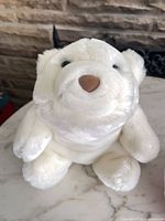 Front view of white Snuffles bear plush