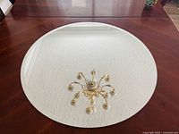 Front view of round mirror on table reflecting ceiling light