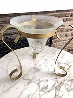 Side view showing glass bowl and brass-tone scroll leg stand