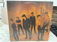 Front of picture sleeve showing band photo and wear