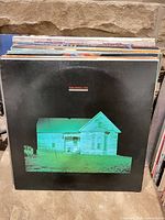 Front cover with green house image