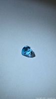 Heart-cut blue topaz on white background, angled view