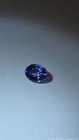 Oval blue-violet faceted gemstone front view