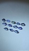 All pear-cut tanzanite stones grouped on flat surface