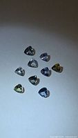 Nine loose trillion cut tanzanite gemstones mixed colours