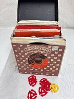 Open record case showing records in sleeves and plastic spindle adapters