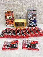 Group shot of sealed Maxell UR cassettes, yellow Shadow case, two Blue Jays VHS tapes