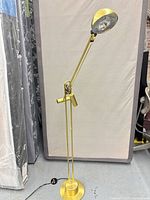 Full view of brass adjustable floor lamp