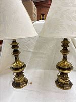 Full view of both brass table lamps with shades