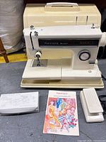 Front view of Kenmore Ultra-Stitch 12 with case, foot pedal, manual, accessory box