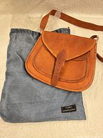 Front of brown leather purse on dust bag