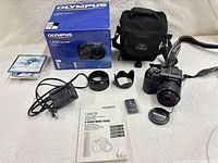 Full lot showing camera, accessories, manual, charger, bag and box