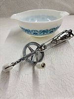 Bowl and rotary beater together showing scale and style