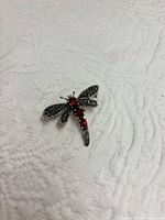 Front view showing marcasite wings and red stones